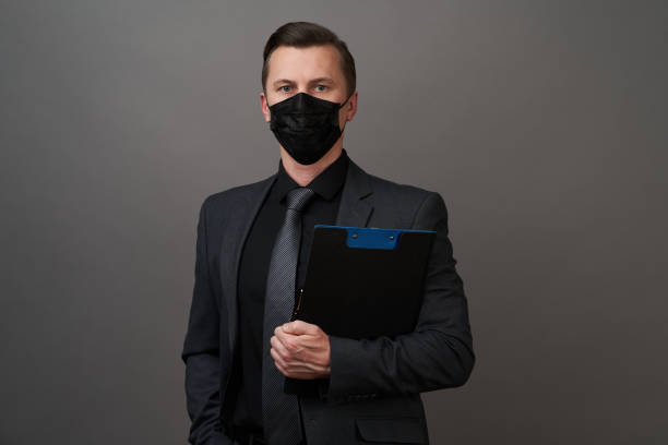 istock Businessman Holding a Clipboard document. Coronavirus pandemic prevention concept 1222549264