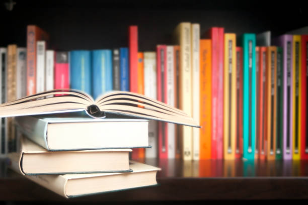 istock Stack of books on a shelf, multicolored book spines. 1222550840