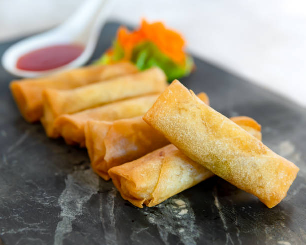 istock Crispy Vegetarian Spring Rolls on Granite Tray with Sweet Chilli Sauce 1222550845