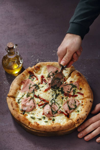 istock Man Cutting Italian Pizza 1222551127