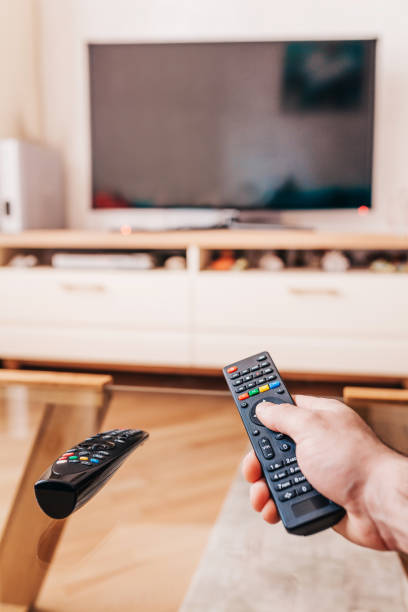 istock The man turns on the TV with the remote control 1222552442