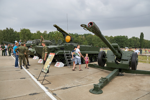 Sambek, Rostov Region, Russia, June 28, 2019: Visitors to the exhibition explore the 122-mm Soviet howitzer D-30A (GRAU index 2A18)