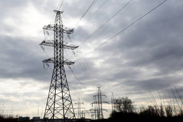 istock High voltage towers with electrical wires on dark cloudy sky background 1222555047