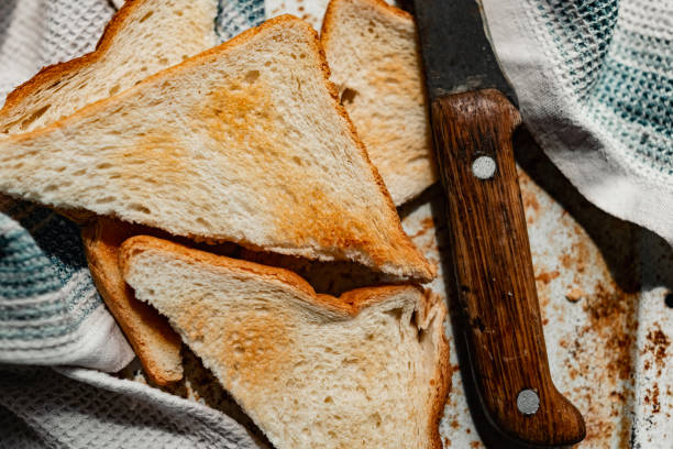 istock Triangular slices of toasted white bread with a soft texture inside and a crisp crust on the outside on a rusty metal background, 1222555606