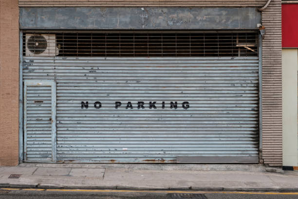 istock closed shutter on store or shop front saying no parking   - 1222557772