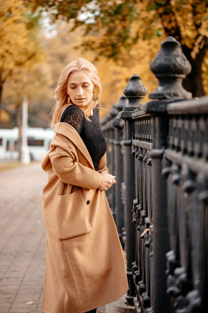istock A woman walks in an autumn park. 1222558083