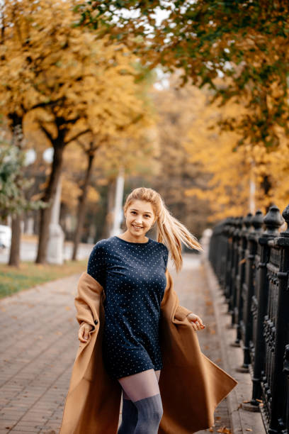 istock A woman walks in an autumn park. 1222558131