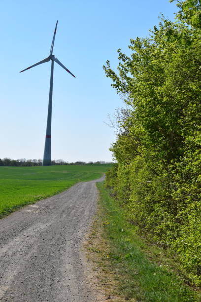 istock dirt road to wind power turbine 1222559232