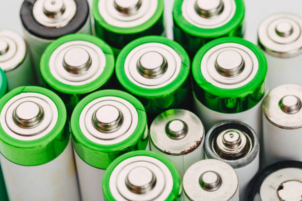 istock many new and used alkaline batteries type AA on a light background. 1222560676