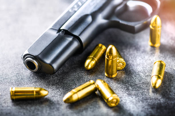 istock Hand gun with ammunition on dark stone background. 1222560824