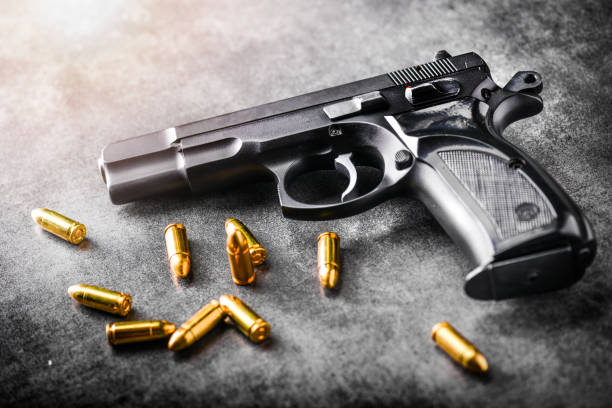istock Hand gun with ammunition on dark stone background. 1222560861