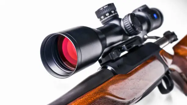 Photo of Detail of rifle telescope for sport hunting isolated on whute background.