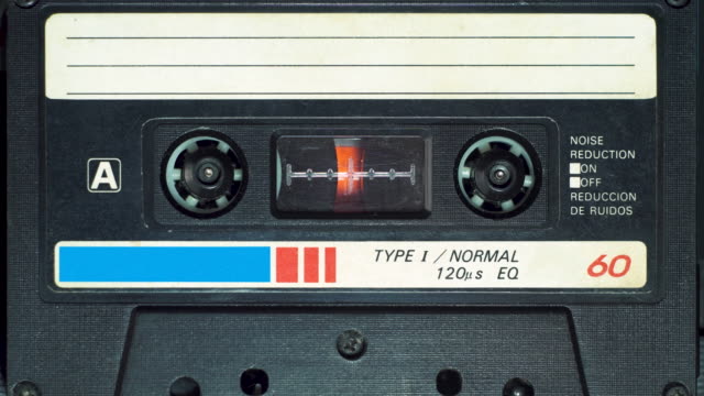 vintage audio cassette begins to play in the tape deck