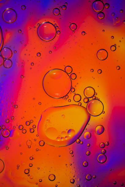 istock Orange and purple background with some oily drops on it. 1222563160