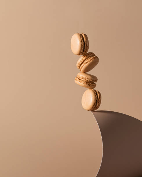 Beige monochrome background with balanced macaroons