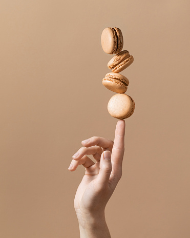 Beige monochrome background with balanced macaroons