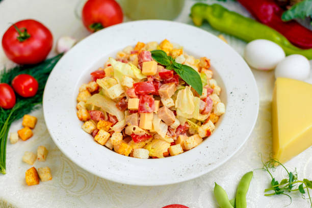 istock fresh salad with chicken, cheese, rusks, lettuce and tomatoes 1222565127