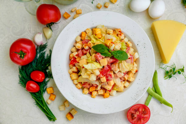 istock fresh salad with chicken, cheese, rusks, lettuce and tomatoes 1222565955