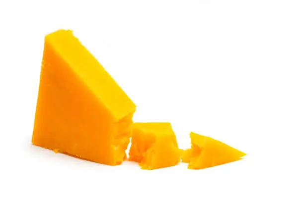 Cheddar Cheese pieces on white background