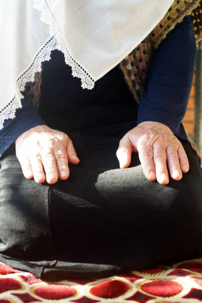 istock Senior woman praying 1222570719