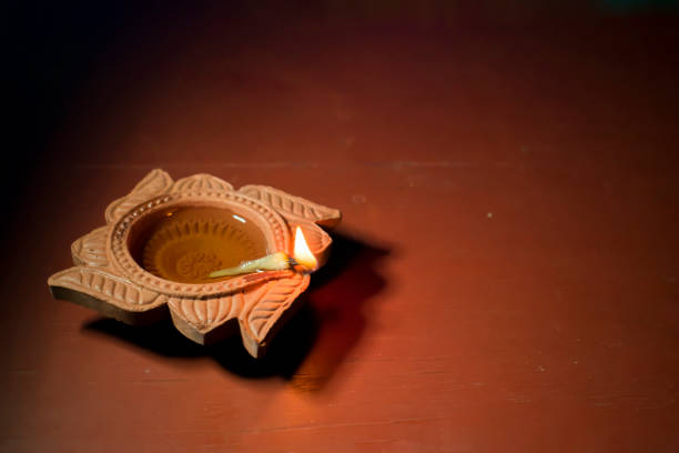 Diya lamps lit with bokeh background during diwali celebration
