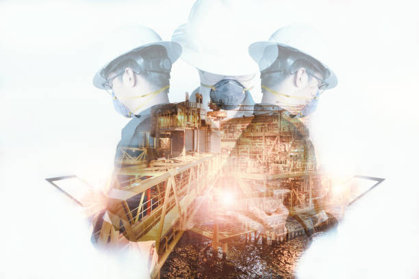 istock Double exposure of Asian Engineer or Technician man wearing N95 mask while using tablet with offshore platform Protection against contagious disease, coronavirus for industrial business concept. 1222572763