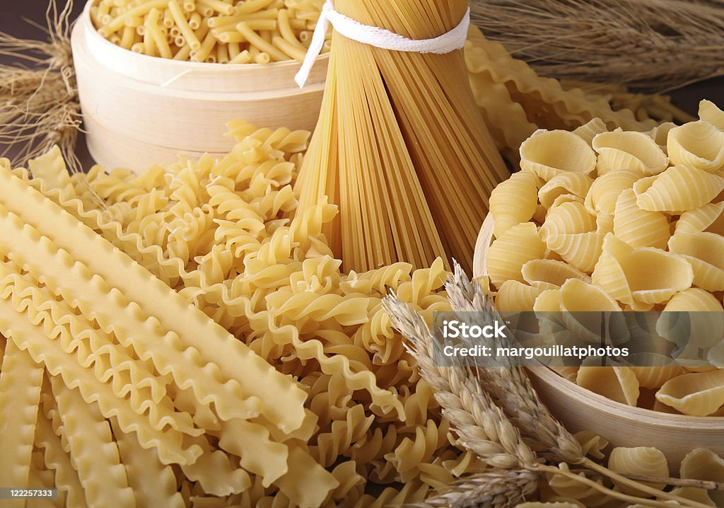 group of uncooked pasta assortment of uncooked pasta and wheat Agriculture Stock Photo