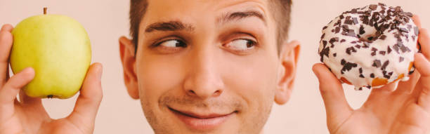 istock Difficult decision what to choose for sports man dieting 1222573417