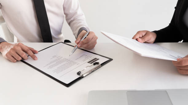 istock Interview employee reading a resume with the job seeker sitting in front 1222573804