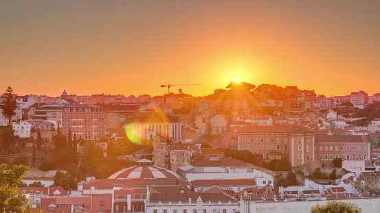 Sunrise over Lisbon aerial cityscape skyline timelapse from viewpoint of St. Peter of Alcantara, Portugal. Historical buildings from above at morning