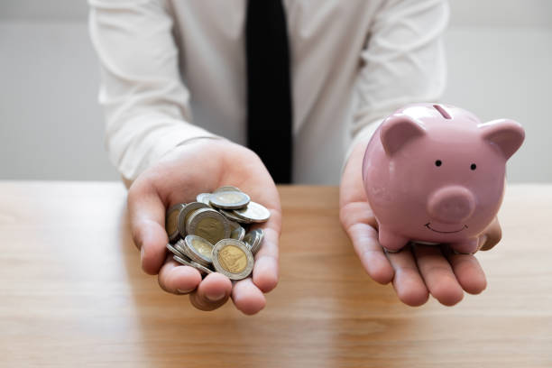 istock Businessman saving golden coin in hands. 1222575439