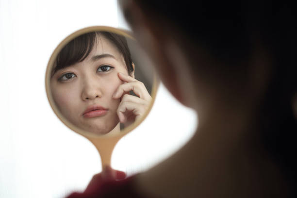 istock Woman looking in the mirror 1222576121