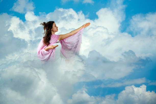 istock Young girl praying in the clouds 1222576999