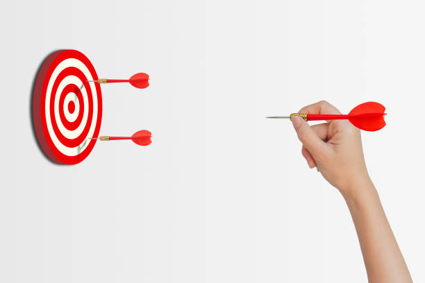 istock Hand holding red dart and throwing to dartboard. 1222578287