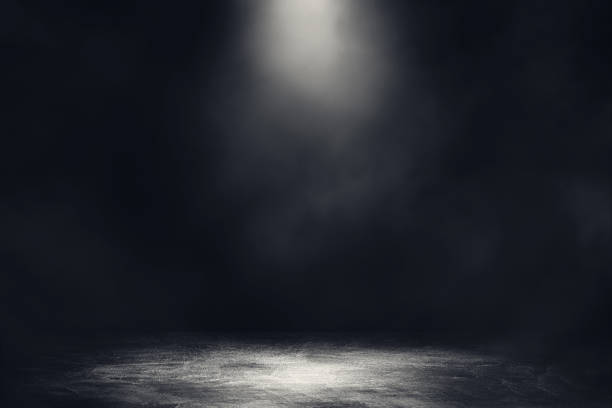istock Empty space studio dark room with spot lighting and fog in black background. 1222578382