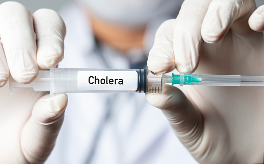 Nurse or doctor holding cholera vaccine.