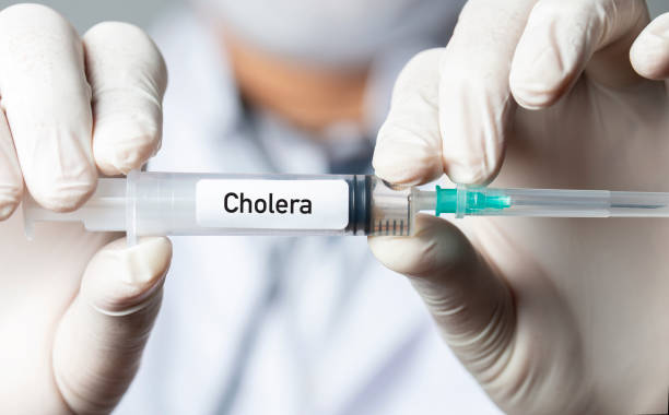 Cholera Vaccine Nurse or doctor holding cholera vaccine. vibrio stock pictures, royalty-free photos & images