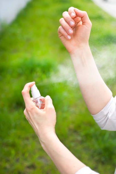 use a spray from mosquito bites. insect repellent. - insect repellant imagens e fotografias de stock