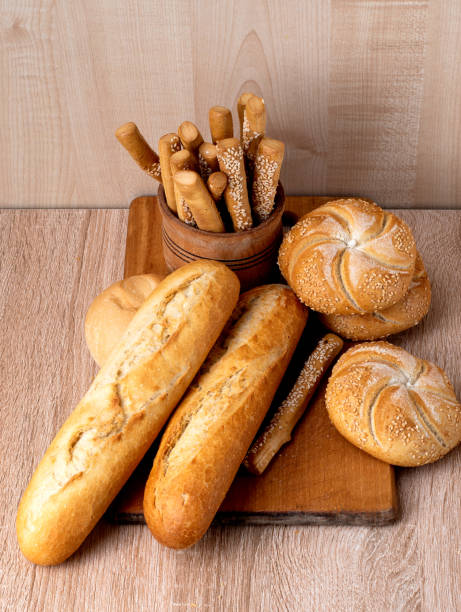 istock Crisp bread with buns. French baguettes. Fresh crispbread. Bread background. Different breed  on wooden background. 1222579146