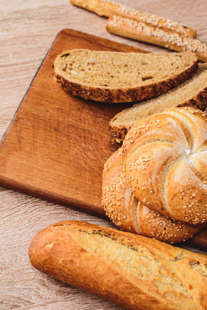 istock Crisp bread with buns. French baguettes. Fresh crispbread. Bread background. Different breed  on wooden background. 1222579162