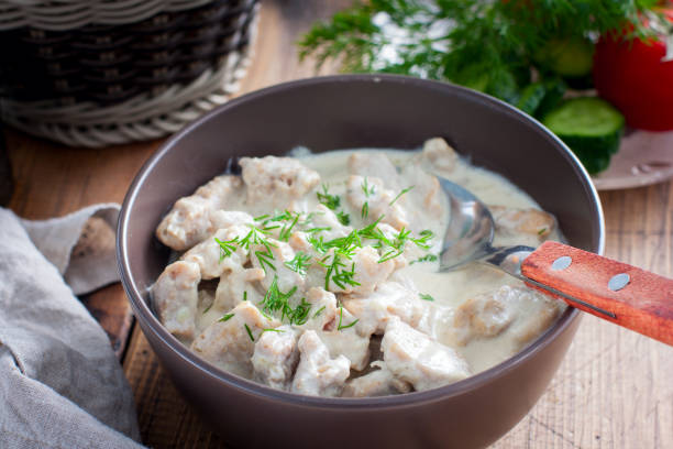 istock Stewed pork in sour cream in a ceramic bowl on a wooden table, selective focus 1222581902