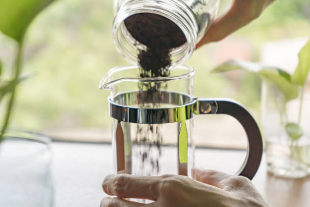 istock Pouring ground coffee into the French press coffee maker 1222582970