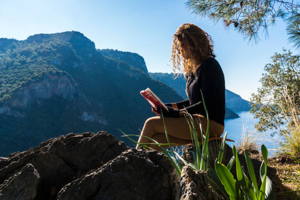 istock Happy woman is reading book. 1222583257