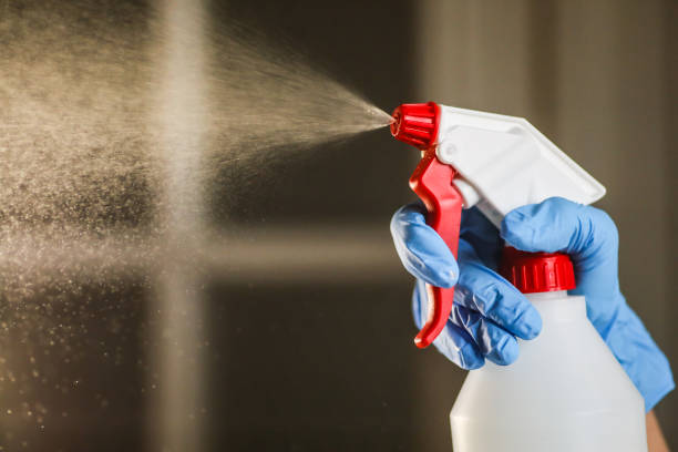 istock Hand with gloves holds a disinfectant dispenser and spraying 1222585906