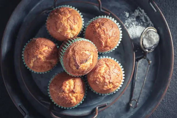 Closeup of yogurt muffins on old metalplate