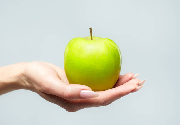 istock a girl with a ripe green apple 1222587660