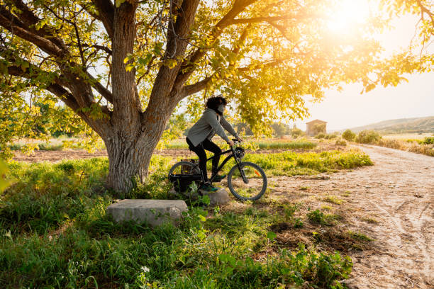 istock Man with surgical mask in the field with his bicycle 1222587729