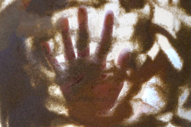 sand therapy, children's hands play with sand on a glass table, bottom view