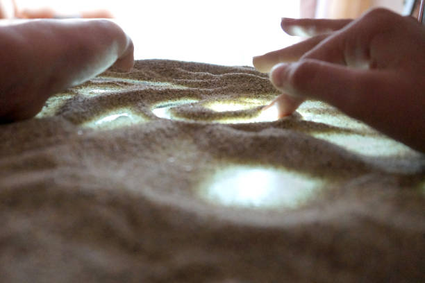 istock children's hands are engaged in sand therapy on a glass transparent table with backlight 1222587845