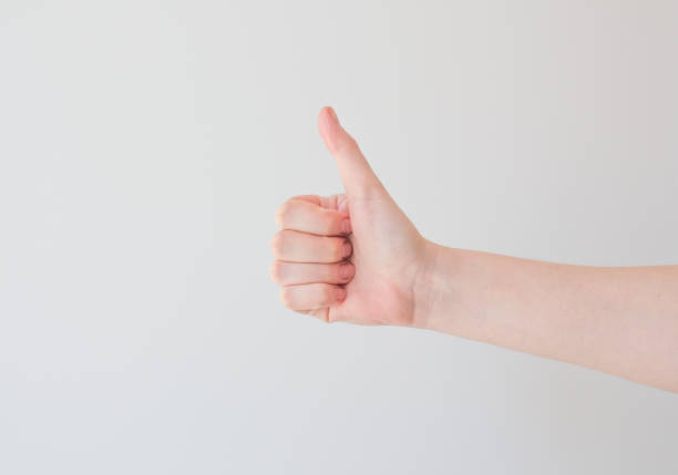 istock thumb up on a white background with extra space. minimal concept, positive thinking. Card with copy space for text 1222588639